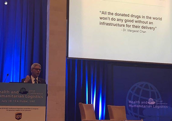 Keynote speaker Jagan Chapagrain discussing quote "All the donated drugs in the world won't do any good without an infrastructure for their delivery"