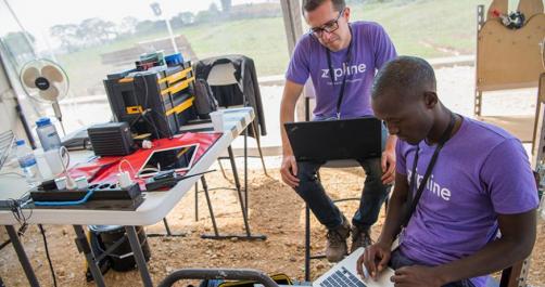 Two Zipline workers assembling drones in Rwanda location