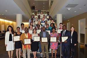 Photo of certificate recipients holding up plaques